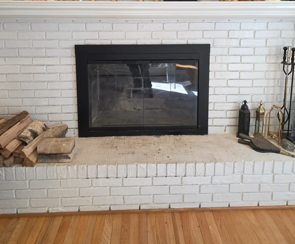 White brick fireplace with black insert in a Baltimore, MD home